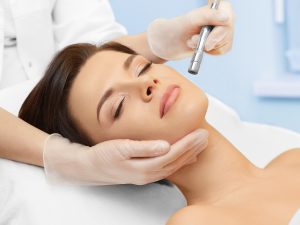 Hardware cosmetology. Spa clinic. Beautiful woman at skin treatment procedure. Microdermabrasion. Young healthy skin. Facial exfoliating. Skin rejuvenation. Beauty treatment. Cosmetology.